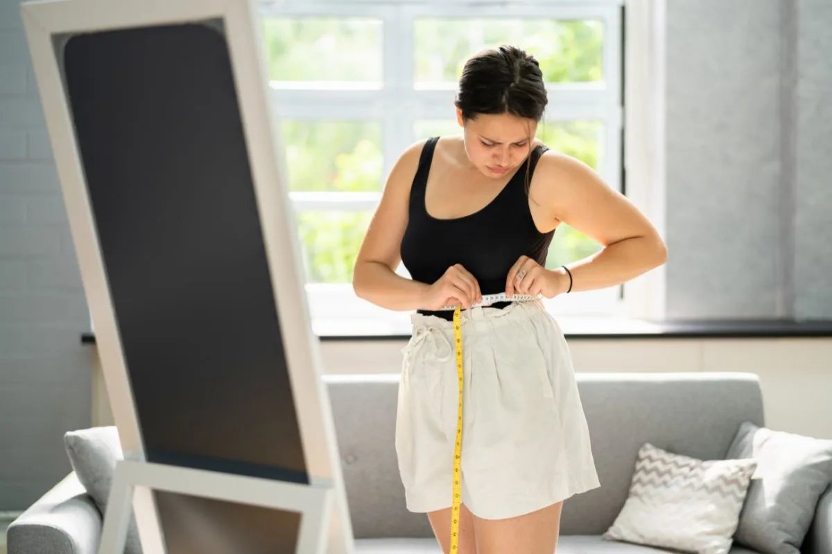 Person exploring weight loss options with a smartphone and medical information
